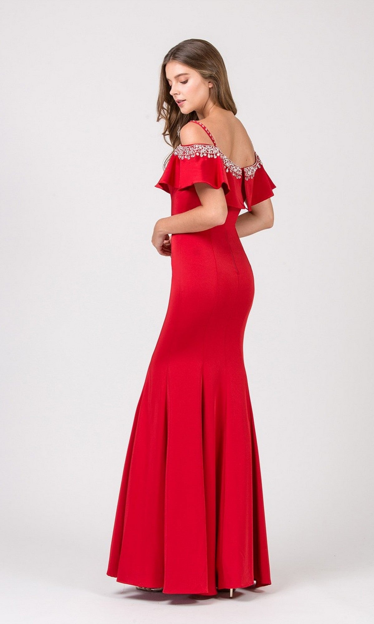 Woman wearing the Eureka 7333 long prom dress, featuring a fitted off-the-shoulder design with ruffled sleeves and beaded details, standing against a plain light background.